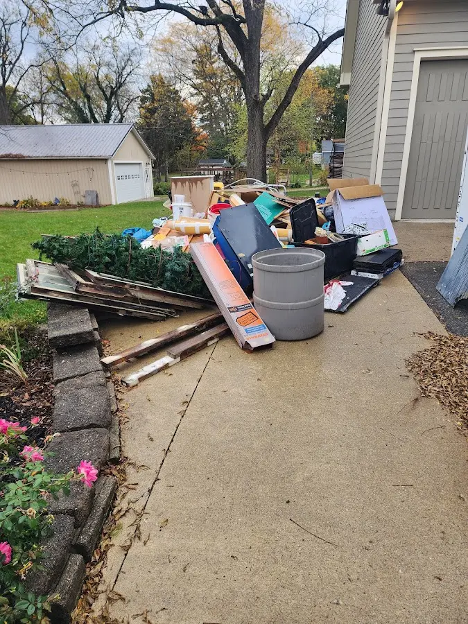Dumpster being loaded with debris for Estate Cleanout Dumpster Rental in Monmouth